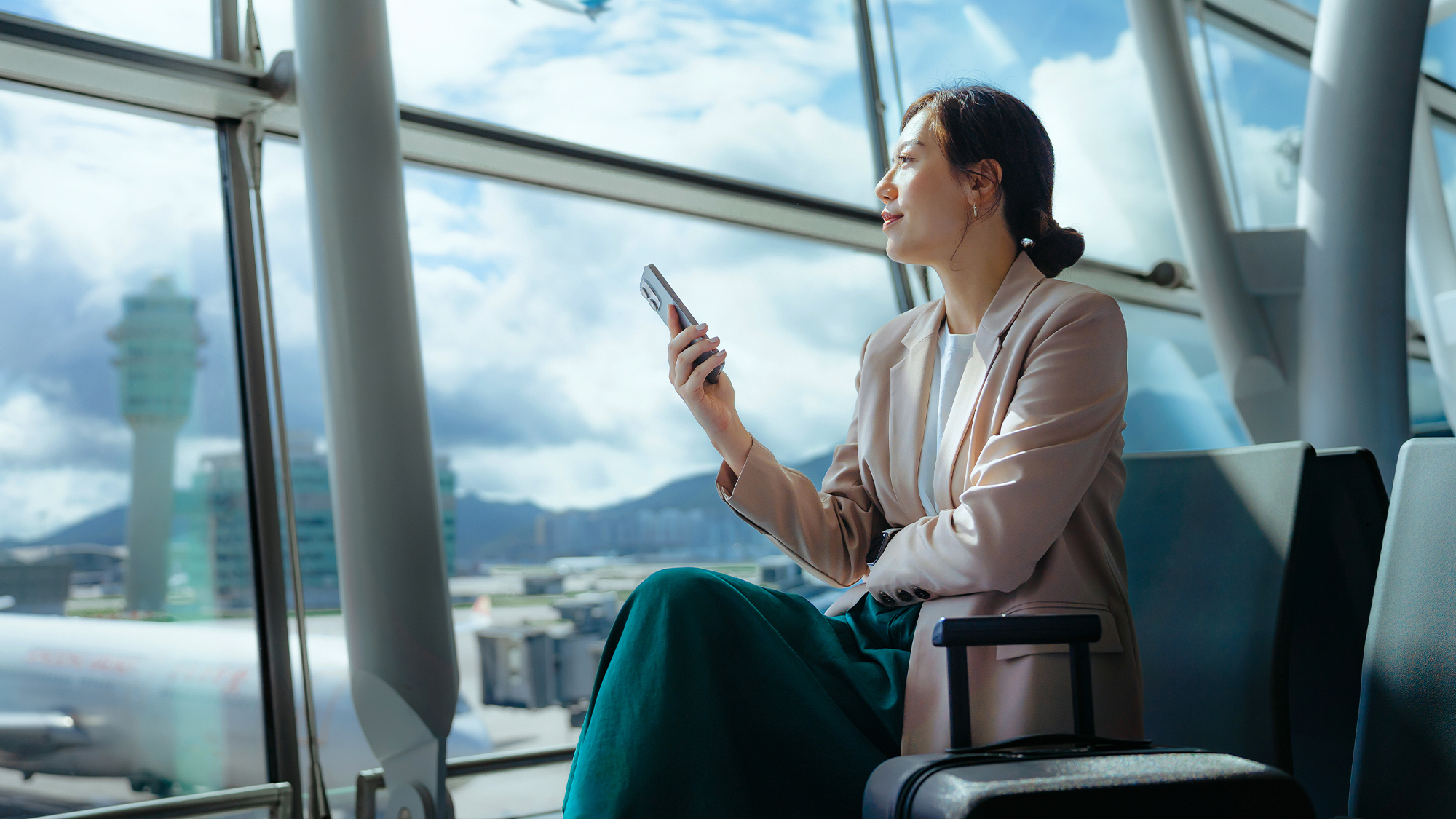 businesswoman-using-phone-at-a-airport