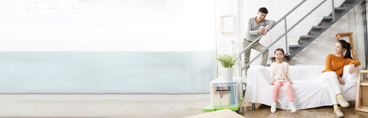 A family of four entering a house carrying some moving boxes; image used for HSBC Vietnam Home Mortgage Loan Page.